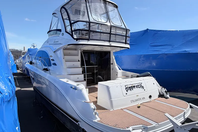 The Image of 2006 Sea Ray 52 Sedan Bridge yacht docked, featuring spacious deck and sleek design. - 0