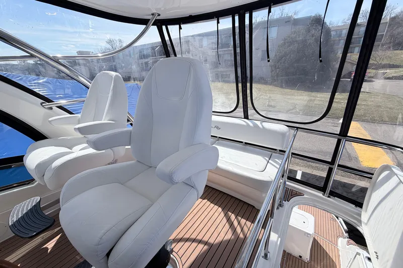 Slide: The Image of Interior of 2006 Sea Ray 52 Sedan Bridge with white captain's chairs and panoramic windows. - 10