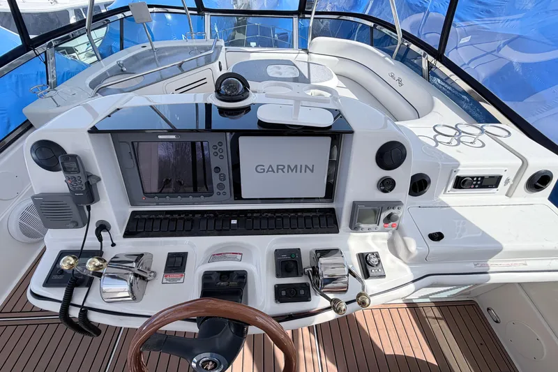 Slide: The Image of Cockpit of 2006 Sea Ray 52 Sedan Bridge with Garmin navigation system and wooden steering wheel. - 12
