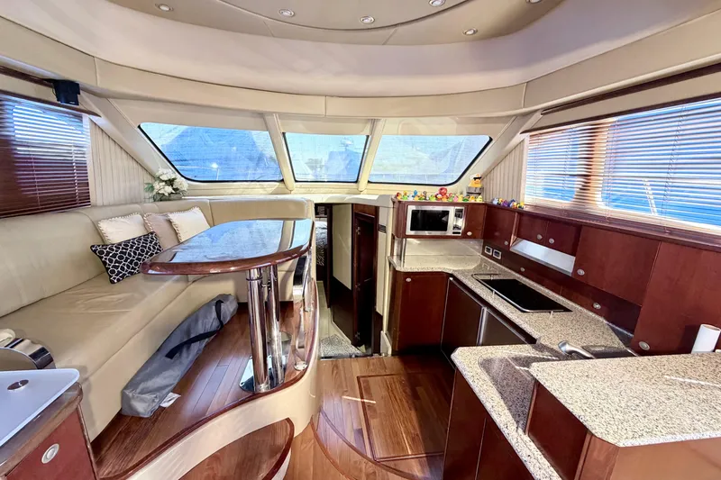 Slide: The Image of Luxurious 2006 Sea Ray 52 Sedan Bridge yacht interior with modern kitchen and seating area. - 21