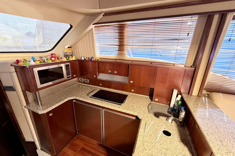 Slide: The Image of Luxurious kitchen interior of 2006 Sea Ray 52 Sedan Bridge yacht with modern amenities. - 22