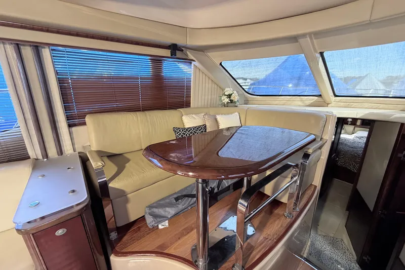 Slide: The Image of Luxurious interior of a 2006 Sea Ray 52 Sedan Bridge yacht with elegant seating and table. - 26