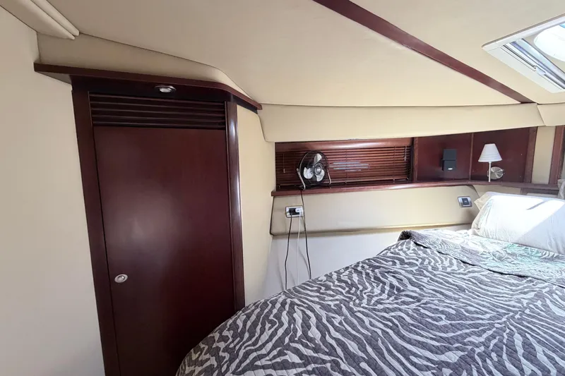 Slide: The Image of Luxurious 2006 Sea Ray 52 Sedan Bridge bedroom with zebra-patterned bedding and elegant wood accents. - 30