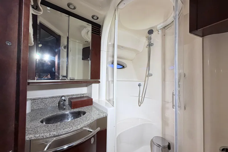 Slide: The Image of Luxurious bathroom in 2006 Sea Ray 52 Sedan Bridge yacht with granite countertop and shower. - 31