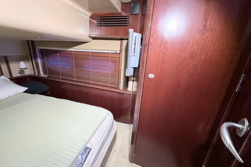 Slide: The Image of Interior cabin of 2006 Sea Ray 52 Sedan Bridge with wooden finishes and bed. - 37