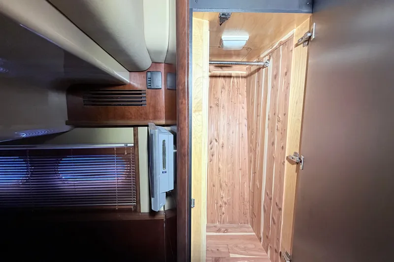 Slide: The Image of Interior of 2006 Sea Ray 52 Sedan Bridge, featuring wooden closet and blinds. - 39