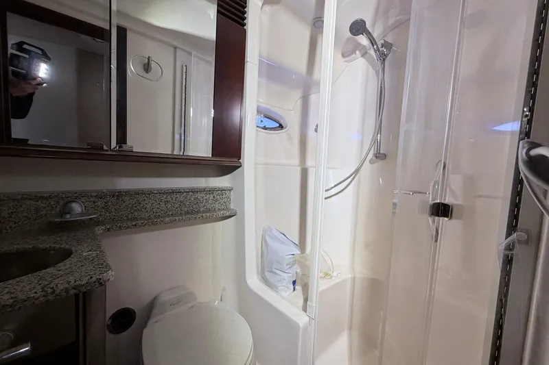 Slide: The Image of Bathroom interior of 2006 Sea Ray 52 Sedan Bridge yacht with shower and granite countertop. - 41