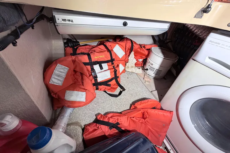Slide: The Image of Life jackets and laundry area on a 2006 Sea Ray 52 Sedan Bridge yacht. - 43