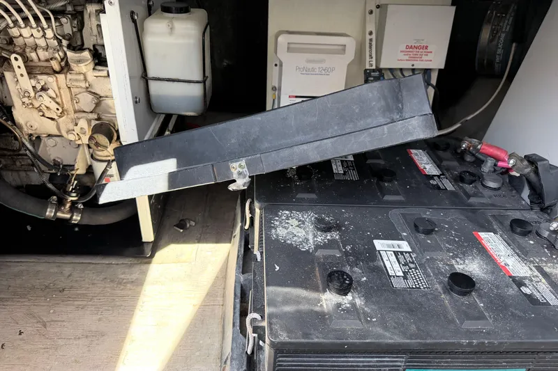 Slide: The Image of Engine compartment of a 2006 Sea Ray 52 Sedan Bridge with visible batteries and components. - 46