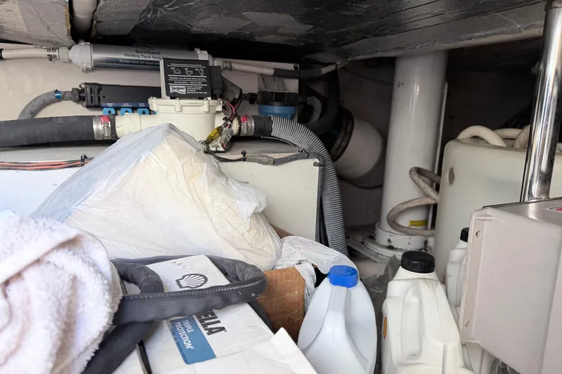 Slide: The Image of Engine room of a 2006 Sea Ray 52 Sedan Bridge with various equipment and supplies. - 51