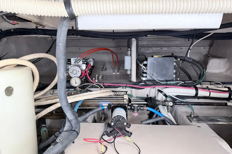 Slide: The Image of Engine room of a 2006 Sea Ray 52 Sedan Bridge with visible wiring and components. - 52