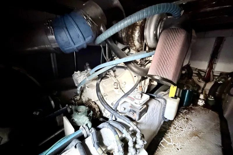 Slide: The Image of Engine compartment of a 2006 Sea Ray 52 Sedan Bridge yacht, showcasing mechanical components. - 53