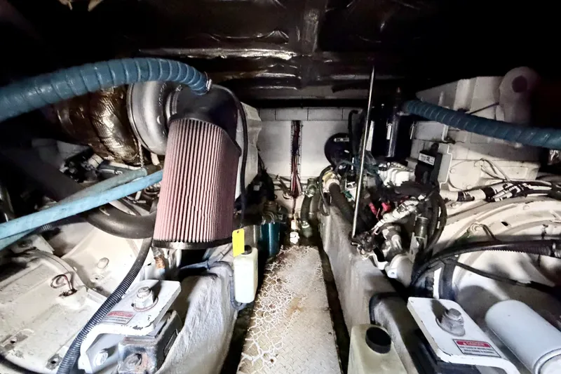 Slide: The Image of Engine room of a 2006 Sea Ray 52 Sedan Bridge yacht, showcasing mechanical components. - 54