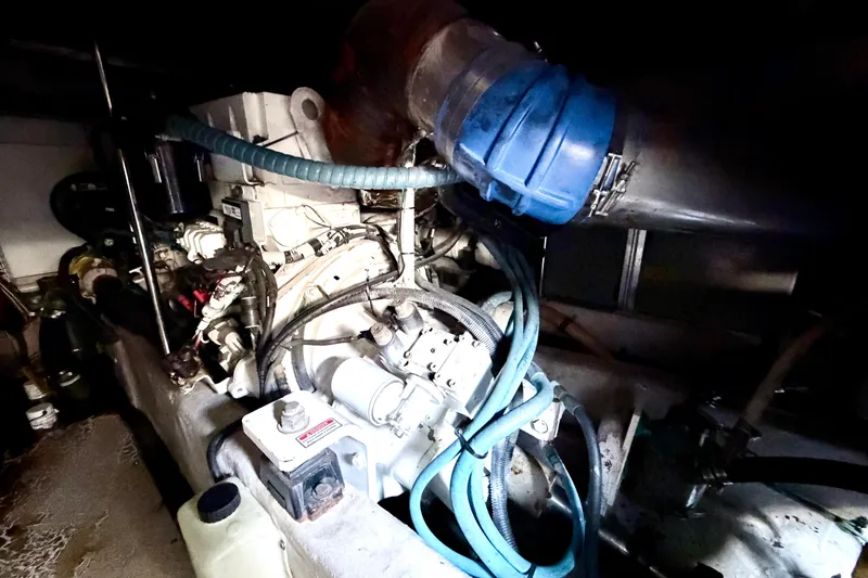 Slide: The Image of Engine compartment of a 2006 Sea Ray 52 Sedan Bridge, showcasing mechanical components and hoses. - 55