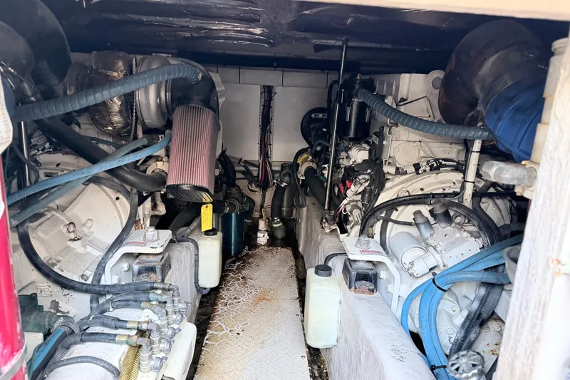 Slide: The Image of Engine compartment of a 2006 Sea Ray 52 Sedan Bridge, showcasing mechanical components and hoses. - 63