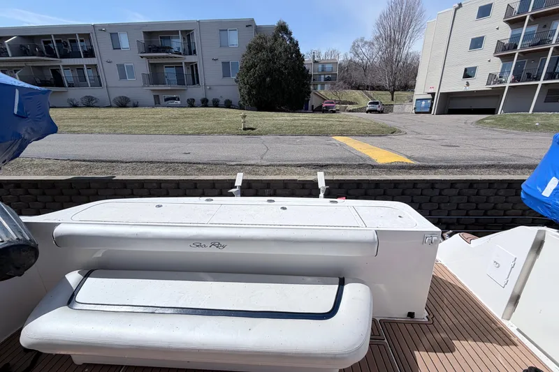 Slide: The Image of 2006 Sea Ray 52 Sedan Bridge yacht with outdoor seating, docked near residential buildings. - 7