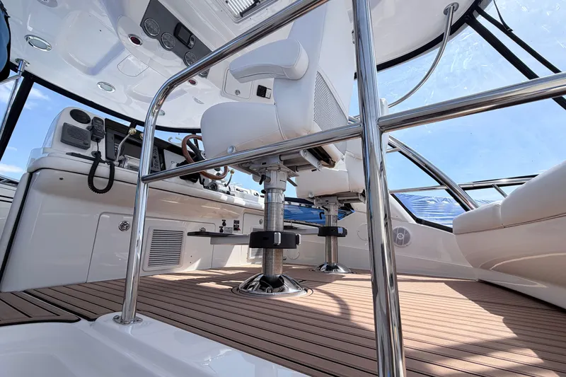 Slide: The Image of 2006 Sea Ray 52 Sedan Bridge helm with modern controls and seating. - 8