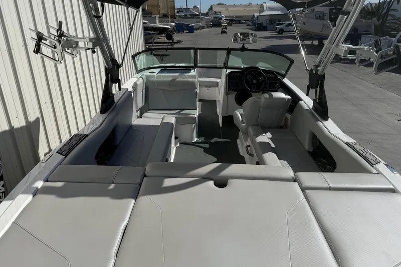 Slide: The Image of 2020 MasterCraft NXT22 boat interior with spacious seating and modern dashboard. - 10