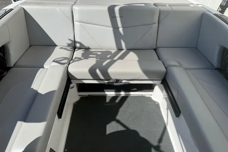 Slide: The Image of 2020 MasterCraft NXT22 boat interior with gray seating and sleek design. - 16