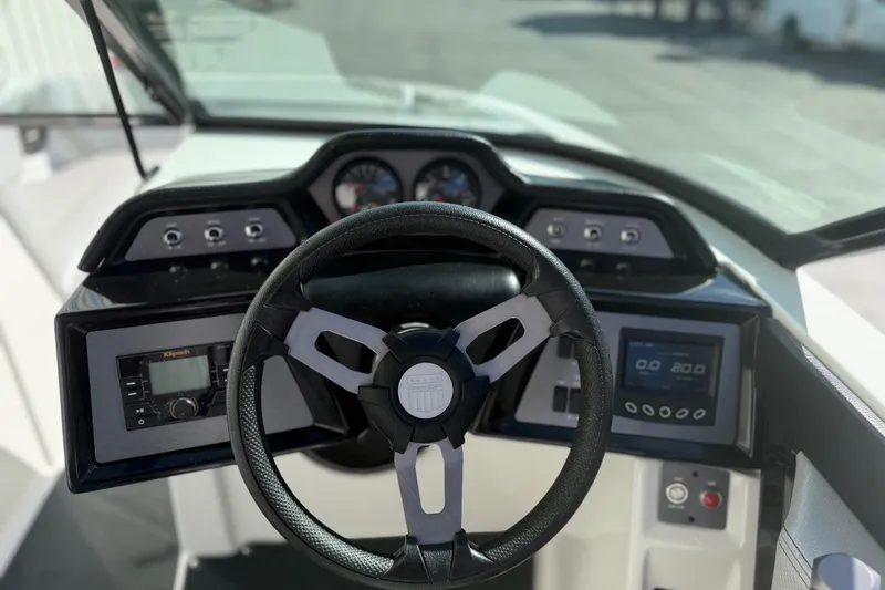 Slide: The Image of 2020 MasterCraft NXT22 boat dashboard with steering wheel and control panels. - 18