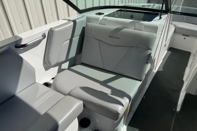 Slide: The Image of 2020 MasterCraft NXT22 boat interior with gray seating and cup holders. - 19