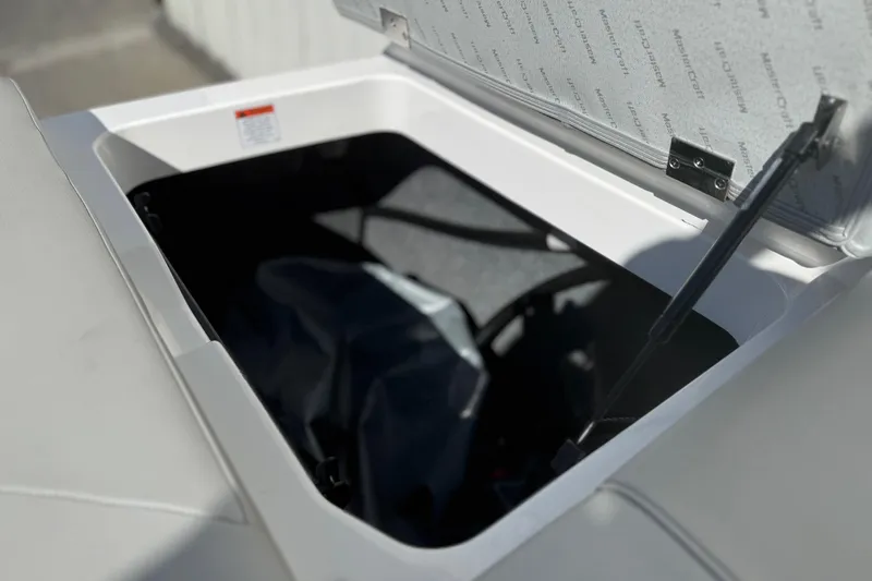 Slide: The Image of Open storage compartment in 2020 MasterCraft NXT22 boat, showcasing interior details. - 21