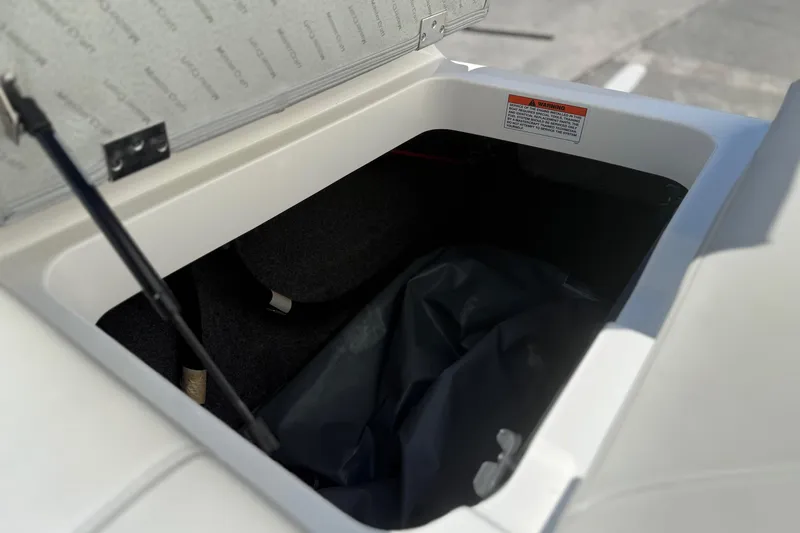 Slide: The Image of Storage compartment of 2020 MasterCraft NXT22 boat, open with visible interior details. - 22