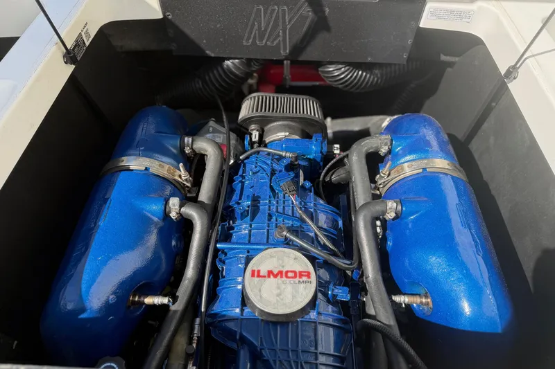 Slide: The Image of 2020 MasterCraft NXT22 engine compartment featuring Ilmor marine engine components. - 25