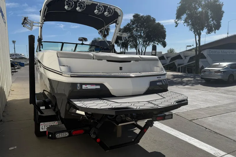 Slide: The Image of 2020 MasterCraft NXT22 boat on trailer, parked outdoors near Delta Marine. - 5