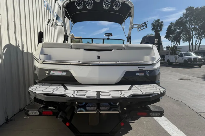 Slide: The Image of 2020 MasterCraft NXT22 boat rear view with swim platform and speakers. - 6