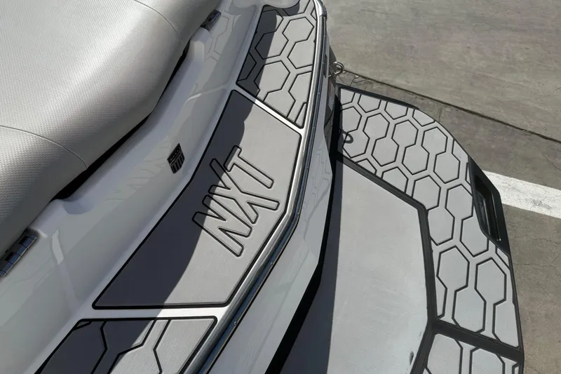 Slide: The Image of 2020 MasterCraft NXT22 boat with hexagonal pattern deck design. - 9