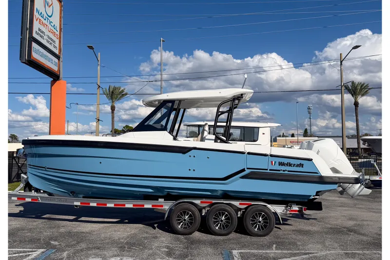 Slide: The Image of 2026 Wellcraft 28 T-Top boat on trailer at Nautical Ventures dealership. - 2