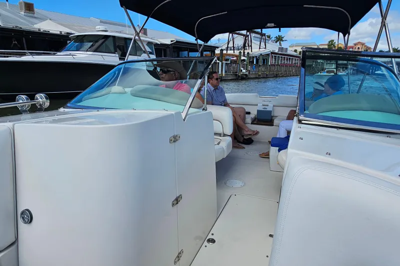 Slide: The Image of 2003 Chris-Craft Launch 28 boat interior with passengers, docked near waterfront buildings. - 14