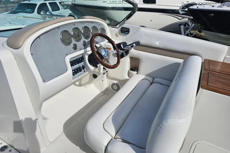 Slide: The Image of 2003 Chris-Craft Launch 28 boat interior with classic dashboard and white seating. - 19