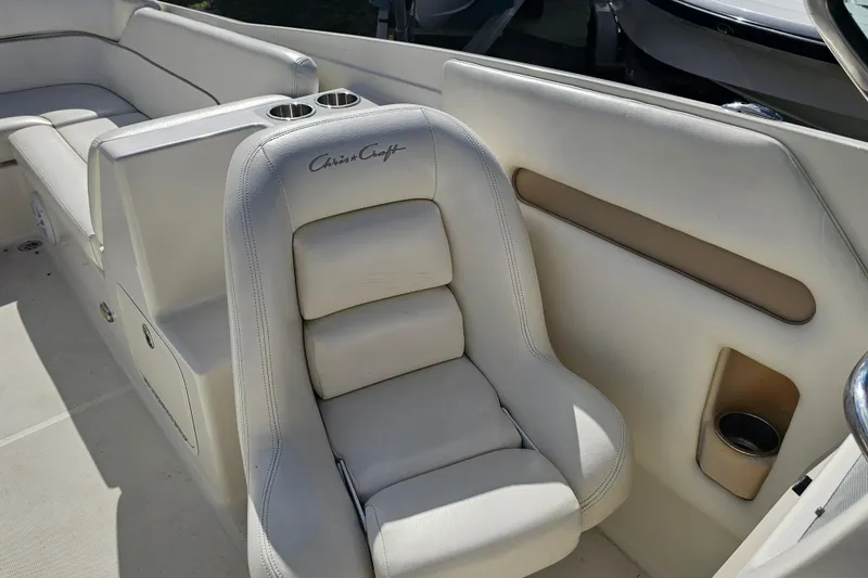 Slide: The Image of 2003 Chris-Craft Launch 28 boat interior with white leather seating and cup holders. - 22