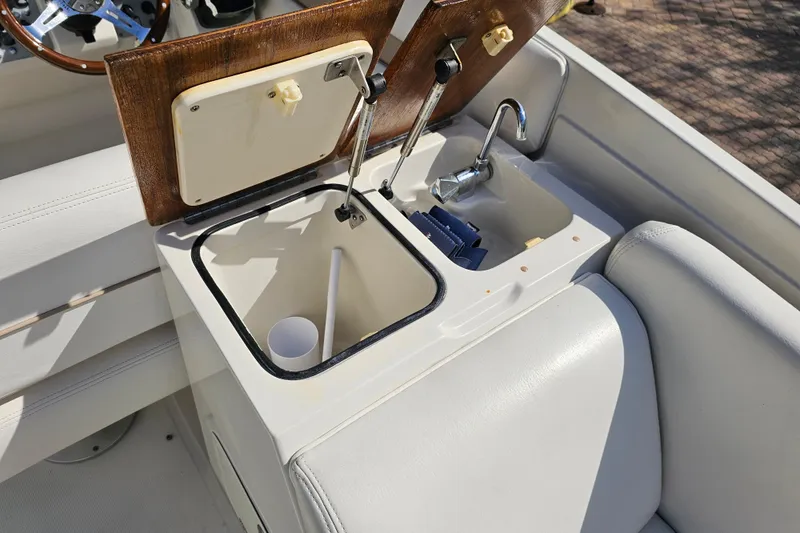 Slide: The Image of 2003 Chris-Craft Launch 28 boat interior with sink and storage compartment. - 29