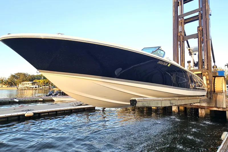 Slide: The Image of 2003 Chris-Craft Launch 28 boat being lifted from the water at a marina. - 4