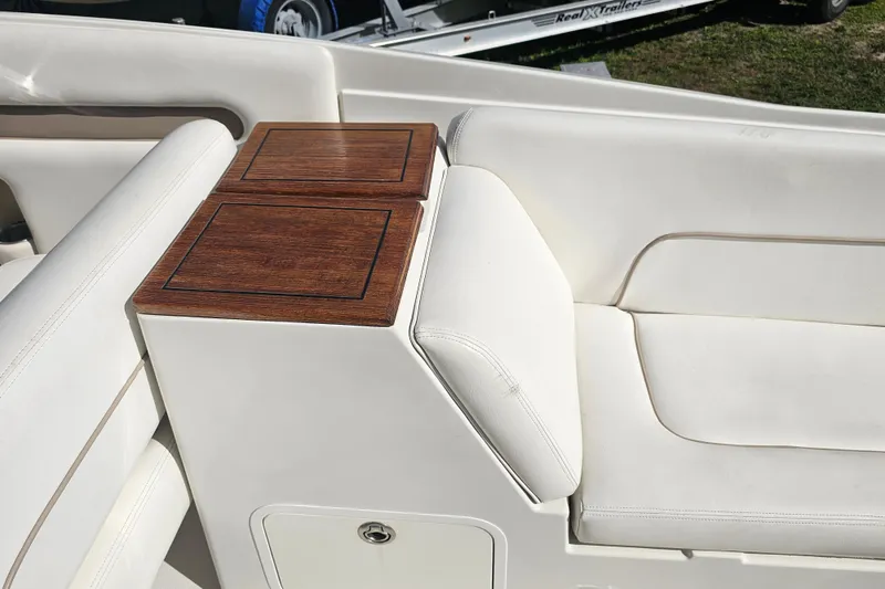 Slide: The Image of 2003 Chris-Craft Launch 28 interior with white seating and wooden accents. - 9