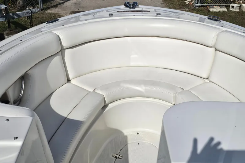 Slide: The Image of 2003 Chris-Craft Launch 28 boat with white seating and wooden accents docked by the water. - 18