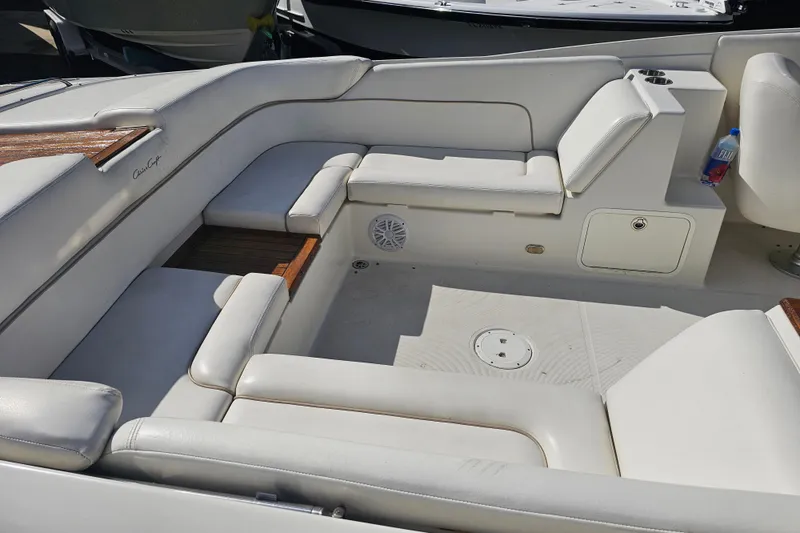 Slide: The Image of 2003 Chris-Craft Launch 28 boat interior with wooden steering wheel and white seating. - 25