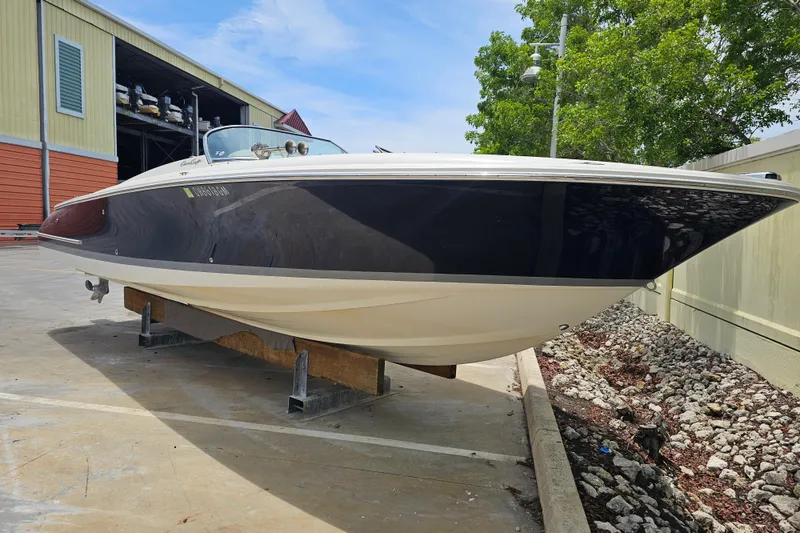 Slide: The Image of 2003 Chris-Craft Launch 28 boat docked at a marina, surrounded by lush greenery. - 6