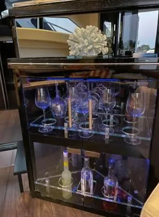 Slide: The Image of Luxury bar cabinet with glassware and bottles on a 2011 Marquis Sport Coupe yacht. - 16