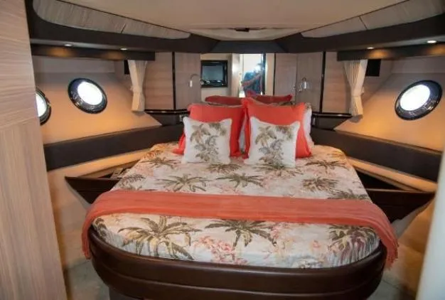 Slide: The Image of Luxurious 2011 Marquis Sport Coupe bedroom with tropical-themed bedding and elegant porthole windows. - 22