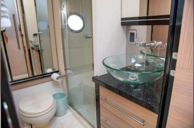 Slide: The Image of Luxurious bathroom in 2011 Marquis Sport Coupe with glass sink and modern fixtures. - 25