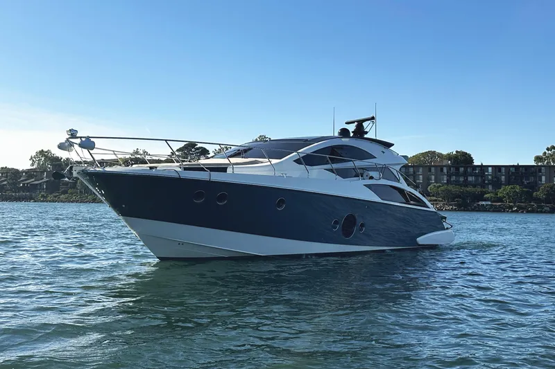 Slide: The Image of 2011 Marquis Sport Coupe yacht on calm water, clear sky background. - 4