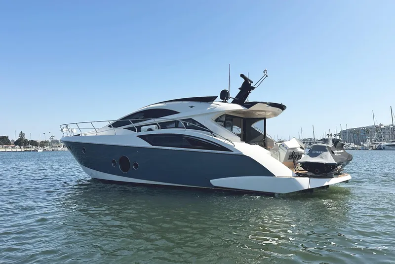 Slide: The Image of 2011 Marquis Sport Coupe yacht on calm water, sleek design, sunny day. - 5