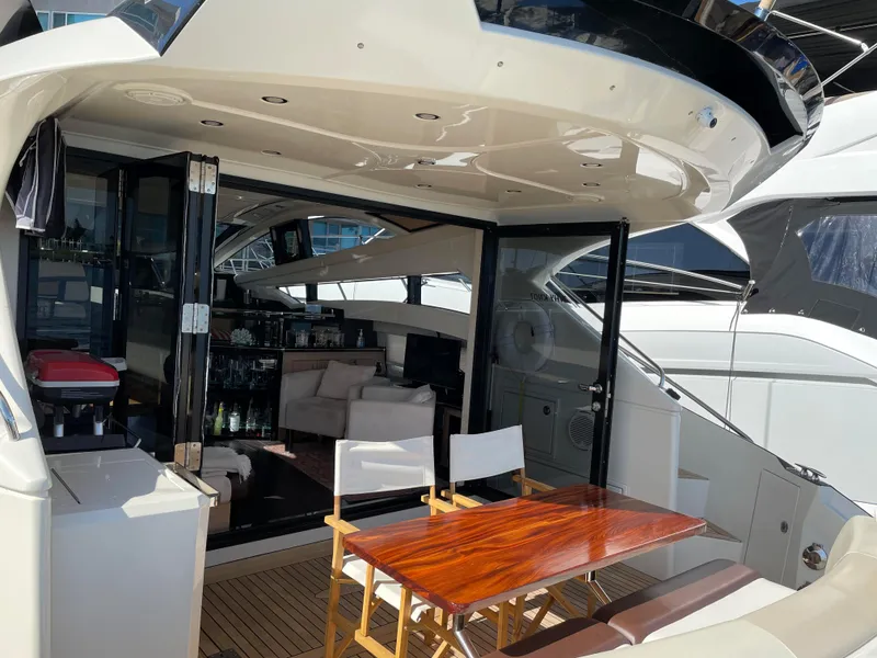 Slide: The Image of Luxurious 2011 Marquis Sport Coupe yacht interior with seating and wooden table. - 7