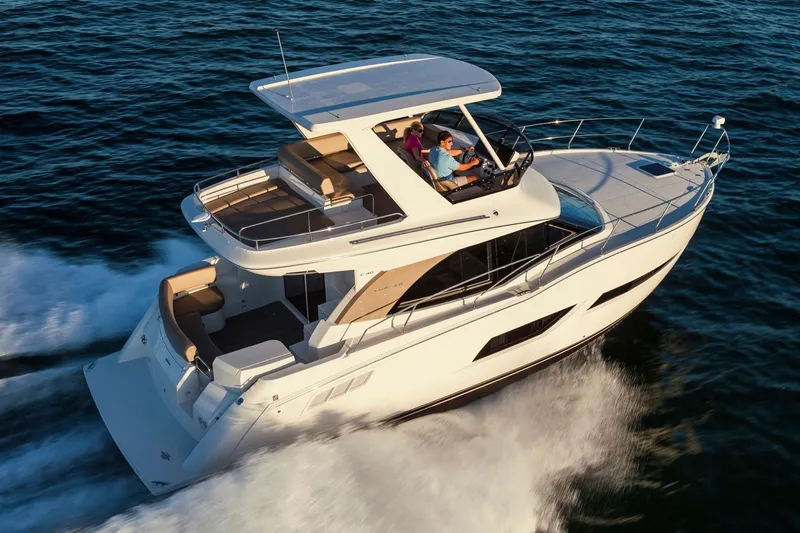 Slide: The Image of Manufacturer Provided Image: 2018 Carver 40 Command Bridge yacht cruising on open water, showcasing sleek design and luxury. - 2