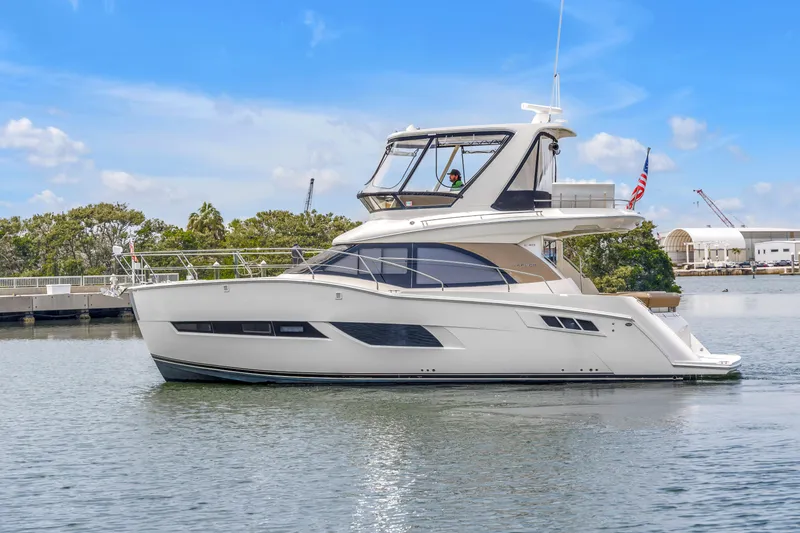 The Image of 2018 Carver 40 Command Bridge yacht on calm water, blue sky background. - 26