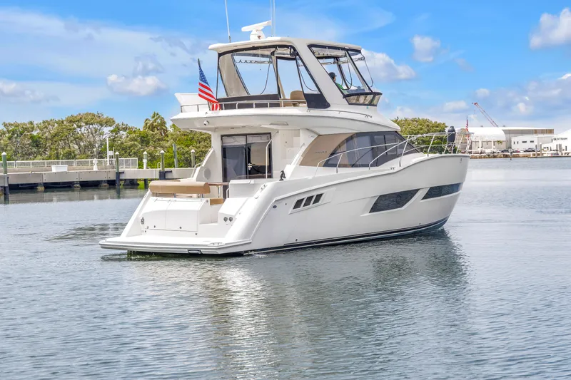 Slide: The Image of 2018 Carver 40 Command Bridge yacht on calm water, featuring sleek design and spacious deck. - 28